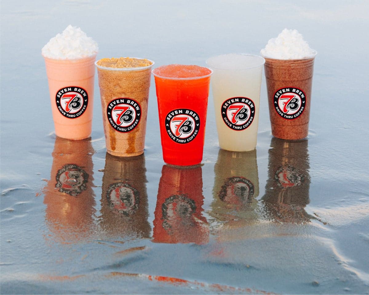 Five 7 Brew drinks lined up on wet surface