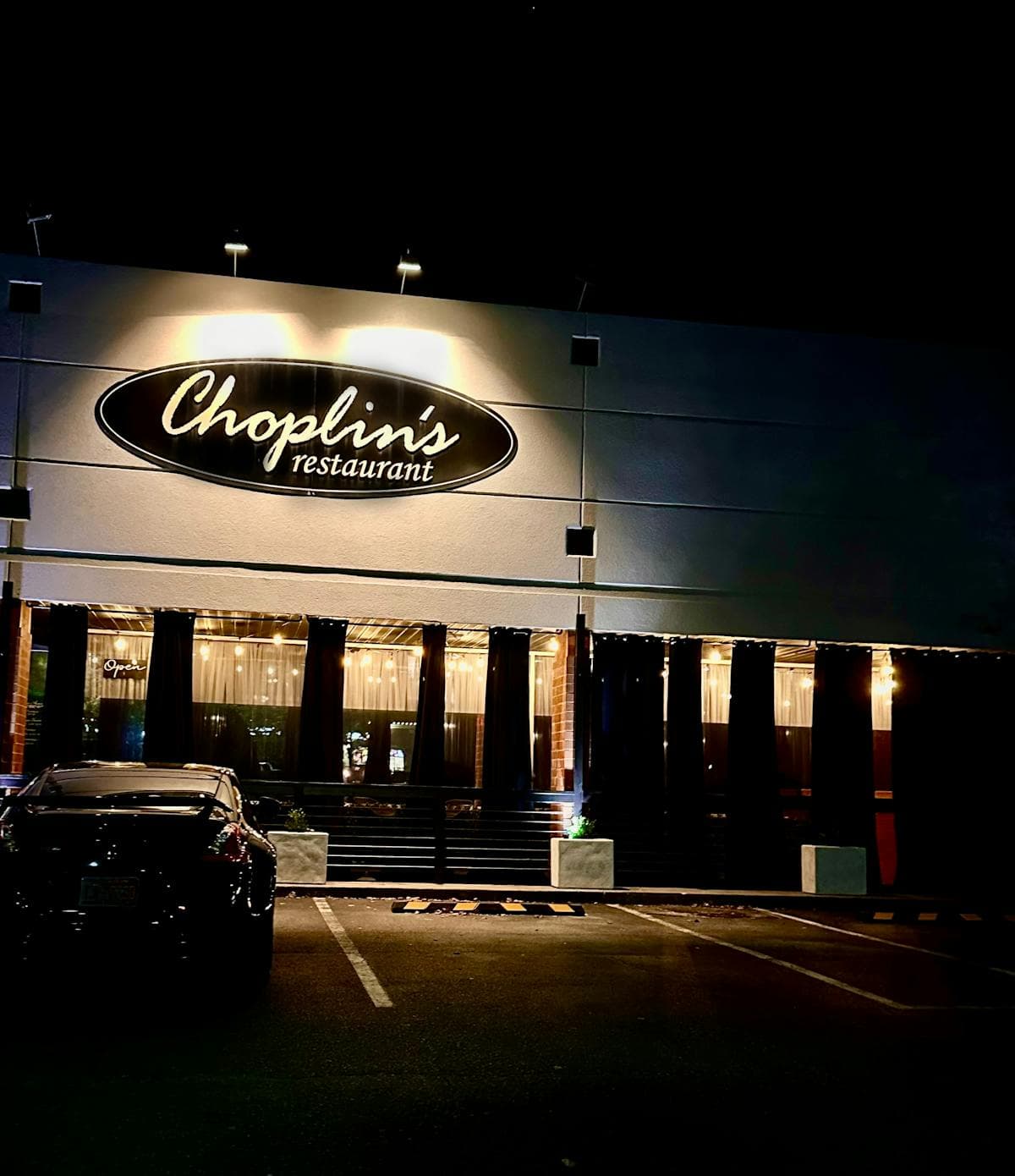 Choplin's restaurant storefront sign at night