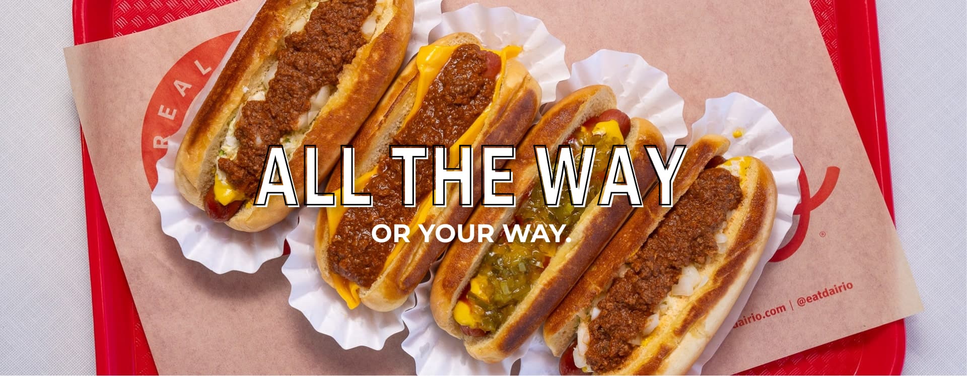 Hot dogs with chili, cheese, onions on tray