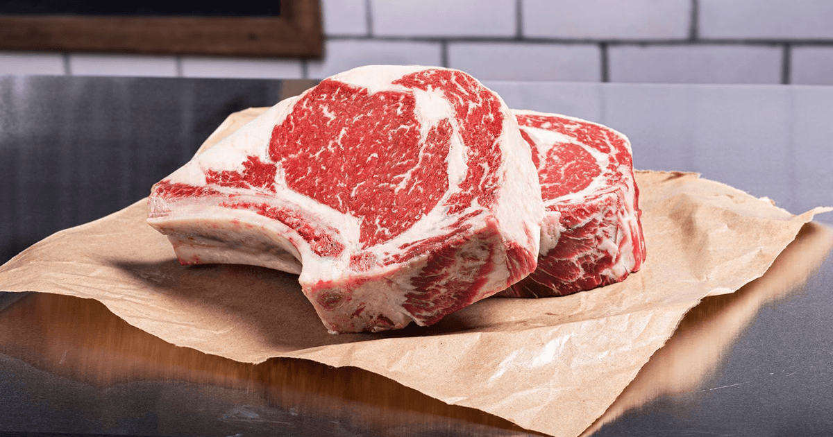 Raw marbled steaks on butcher paper