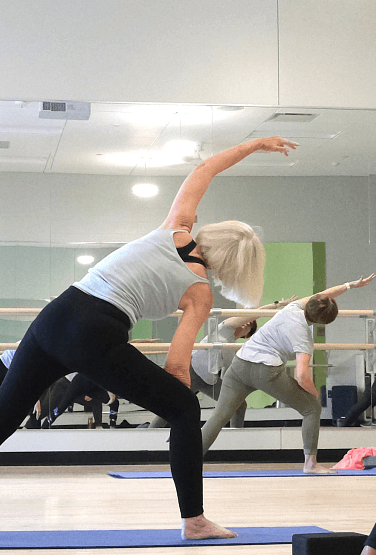 Woman doing yoga stretch in fitness studio