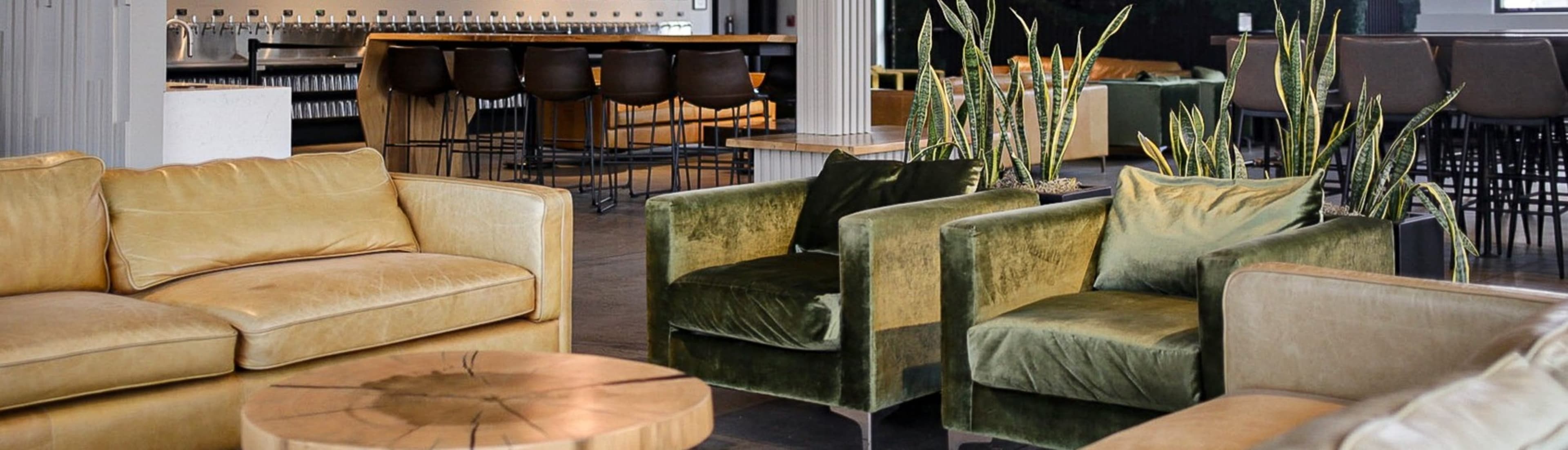 Interior lounge with sofas, bar, and plants