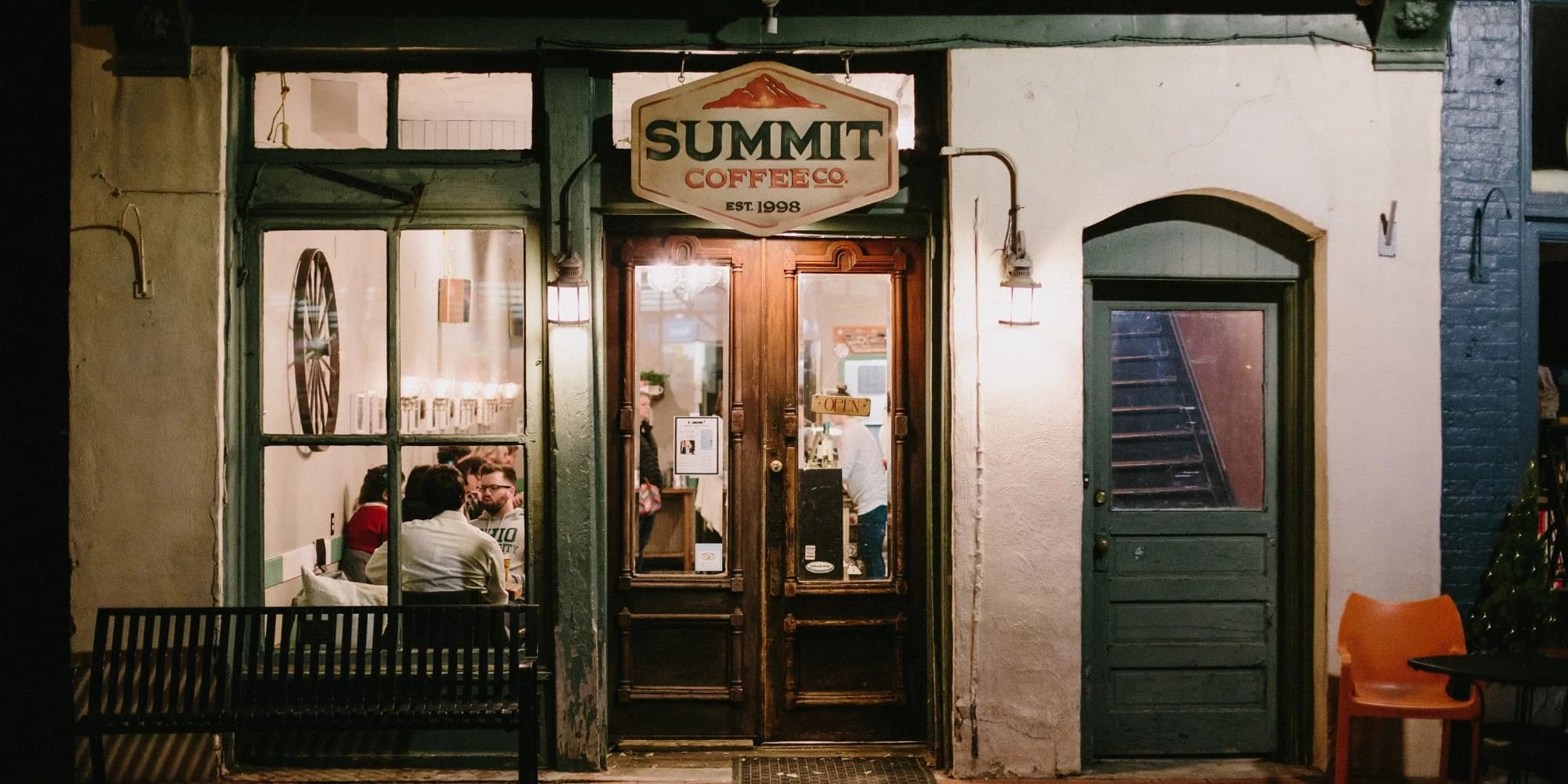 Storefront exterior with Summit Coffee Co sign at night