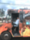 Food truck with flame graphics and person inside