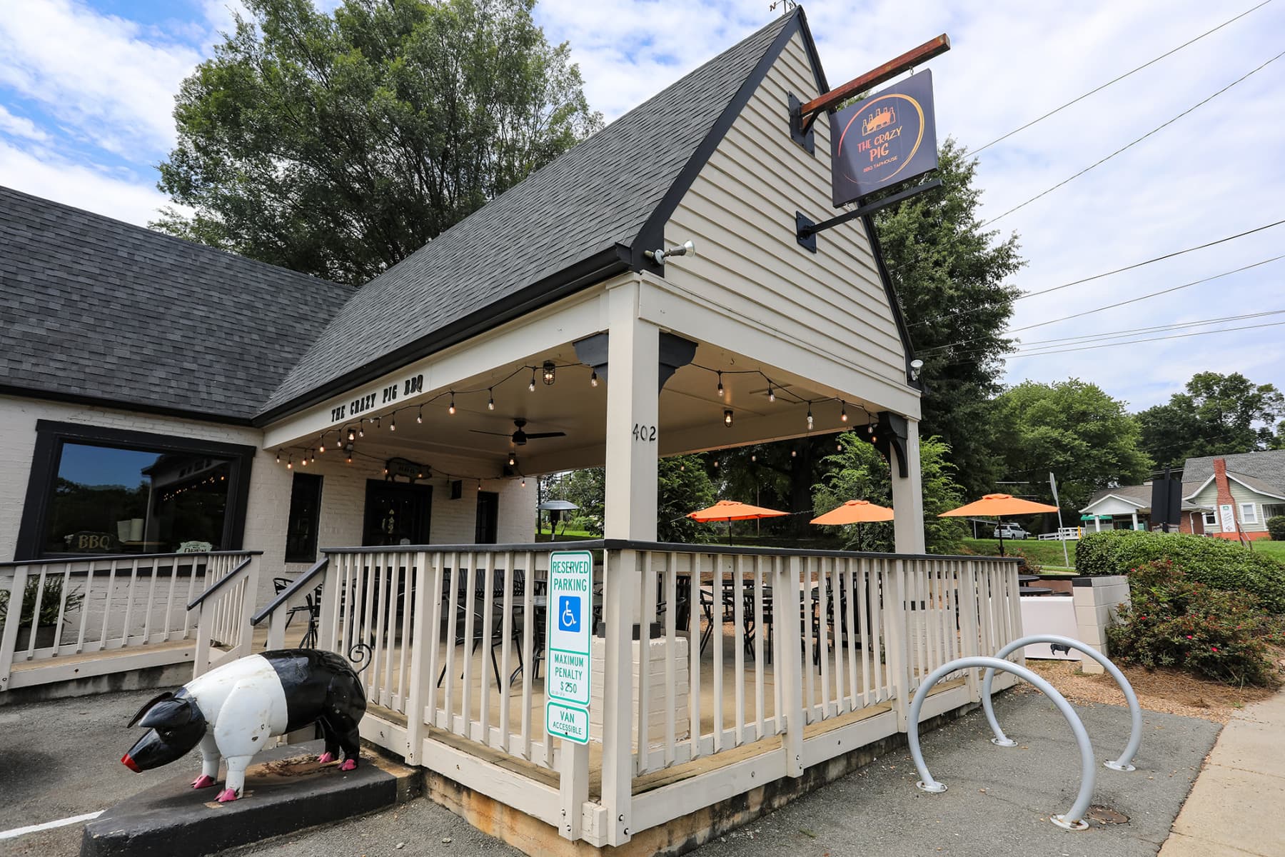 Exterior sign and pig statue at entrance
