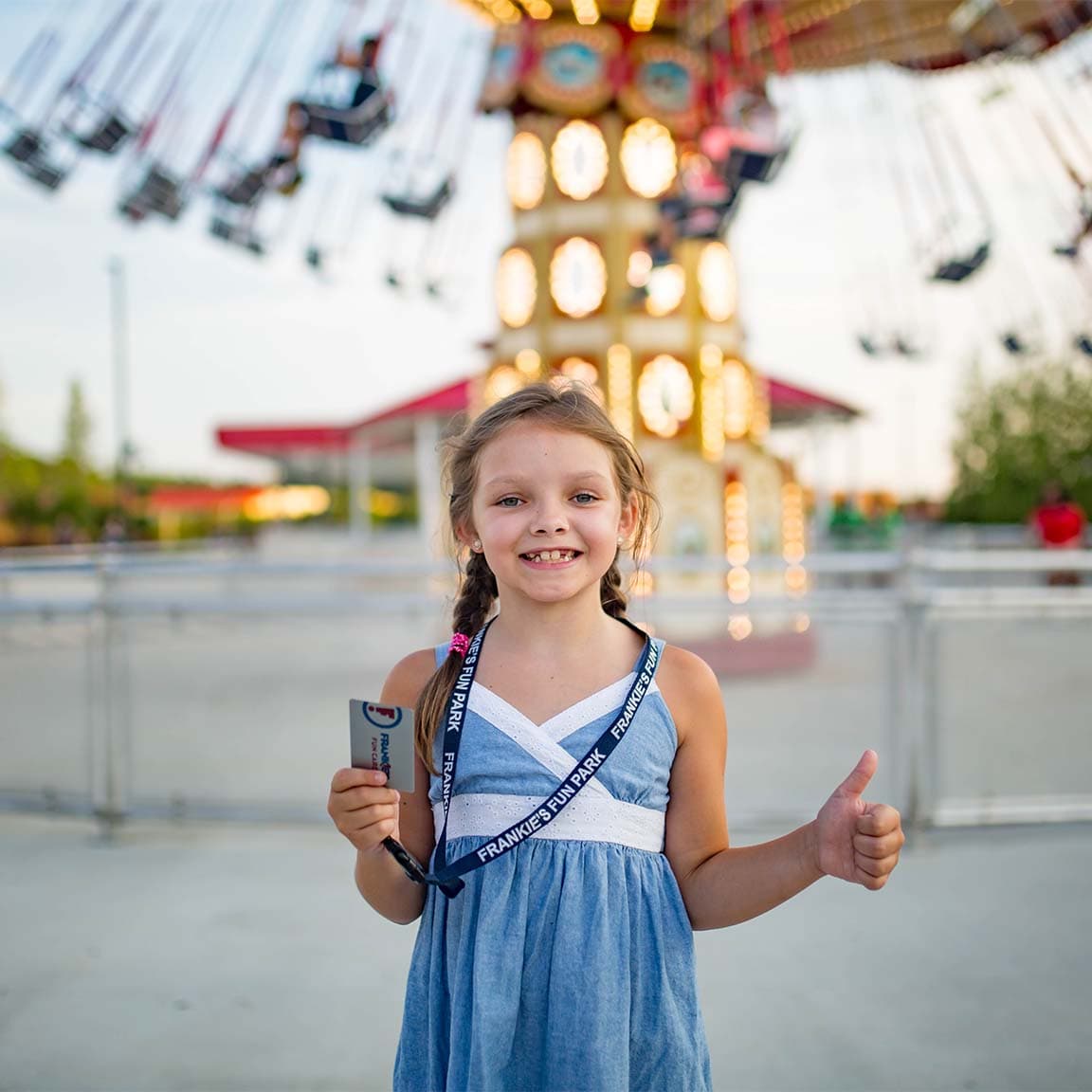 Child at amusement park with lanyard
