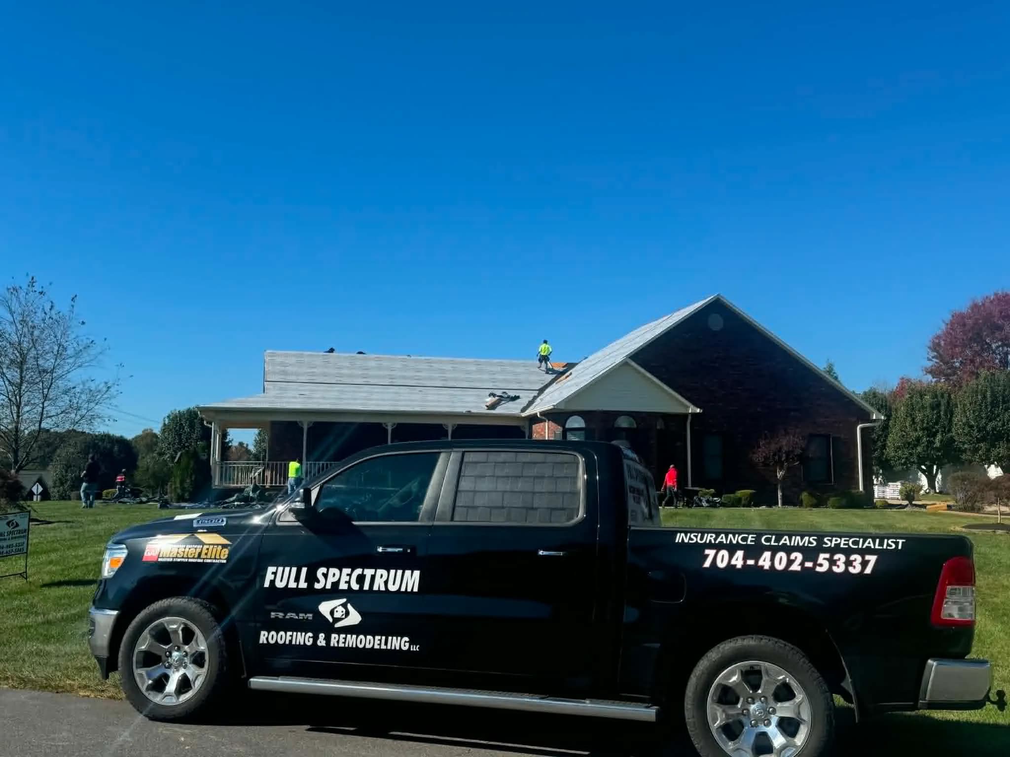 Work truck at residential roofing job site
