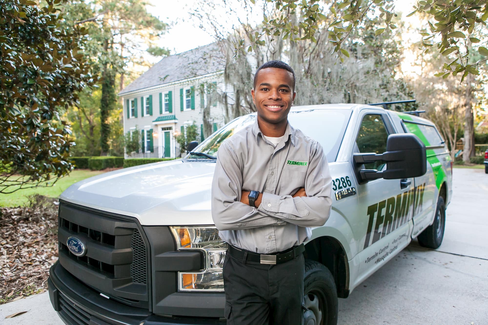 Technician with service van at residential property