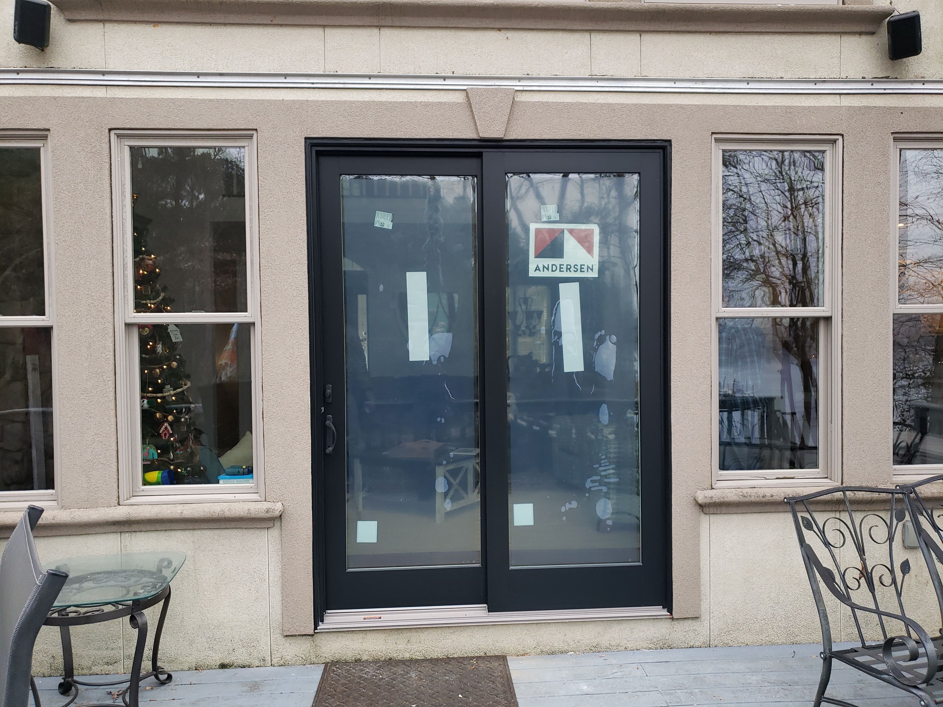 Storefront with black doors and signage