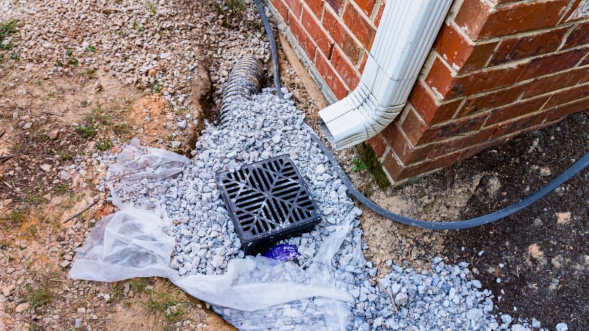 Drainage installation work at house foundation