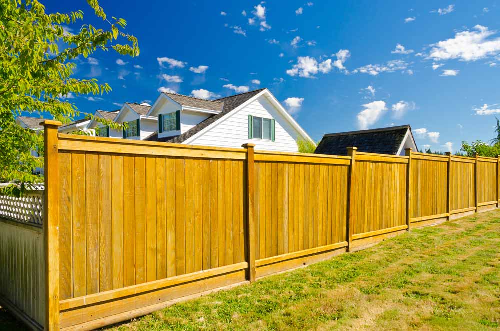 Yellow wooden fence at residential property