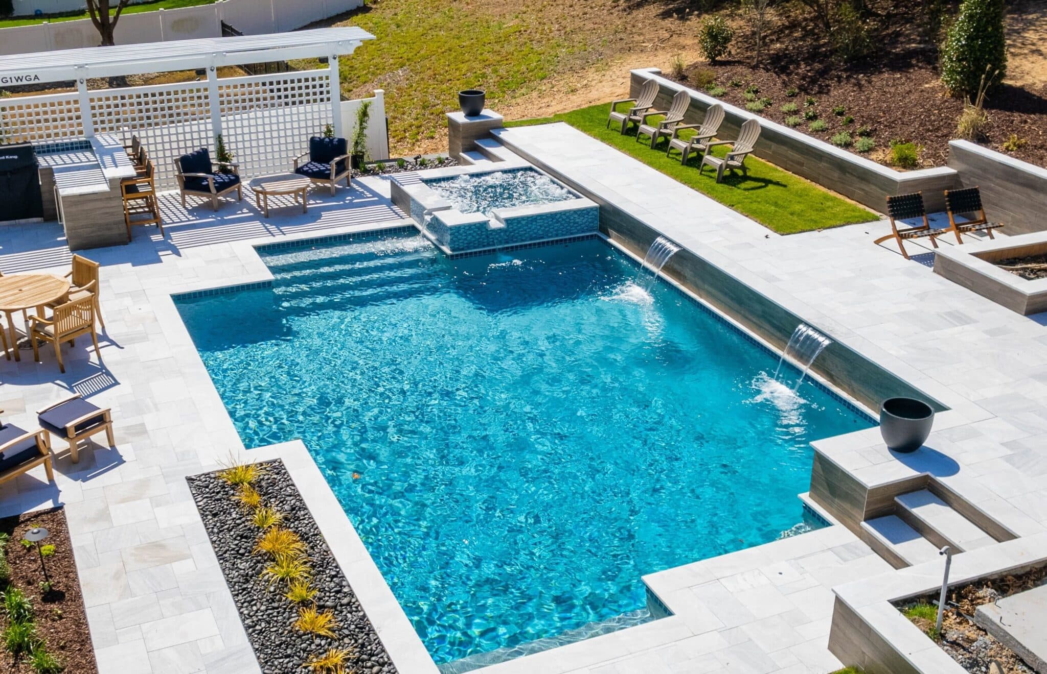 Luxury backyard pool with spa and lounging area