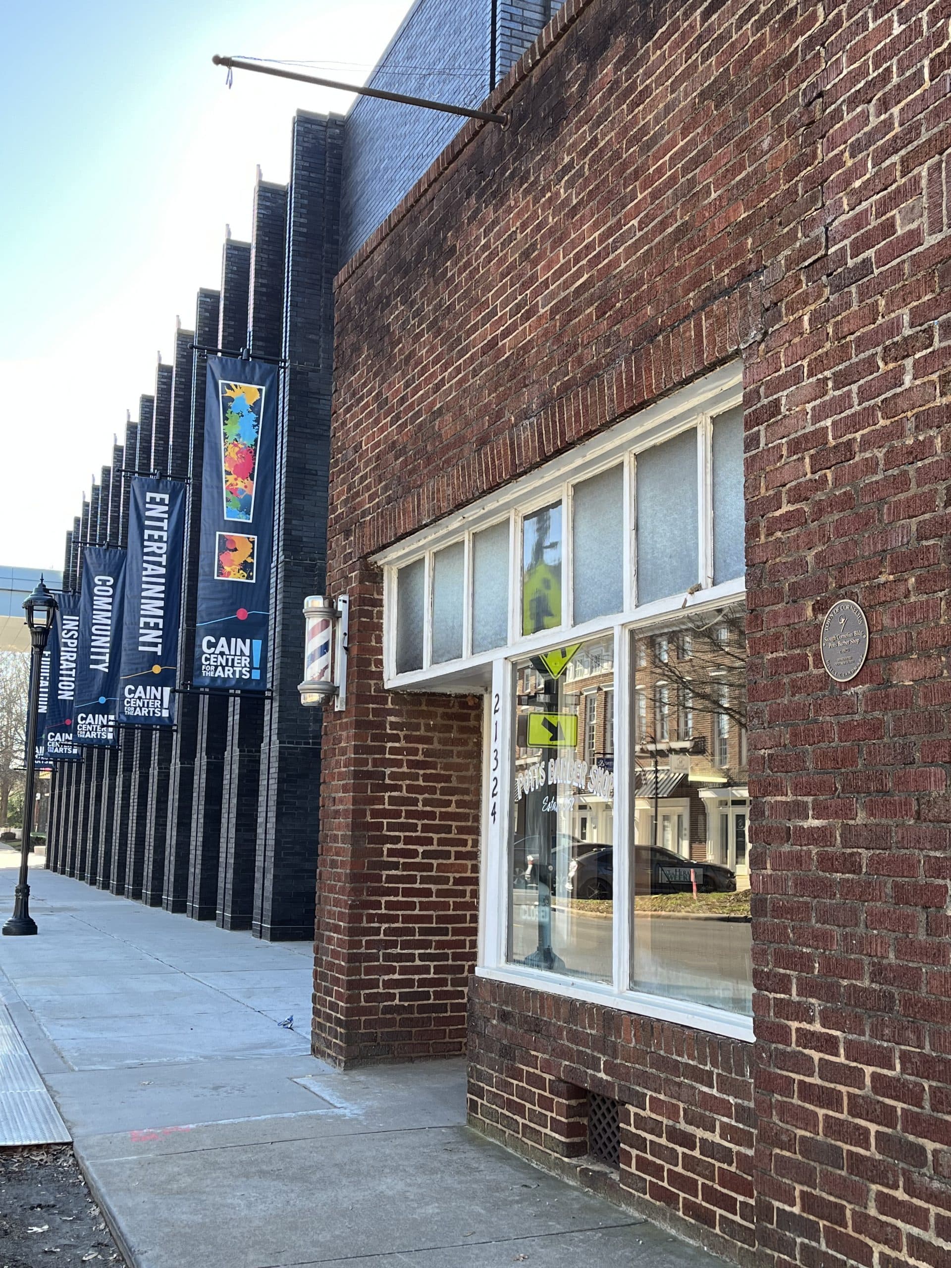 Storefront exterior with barber pole sign