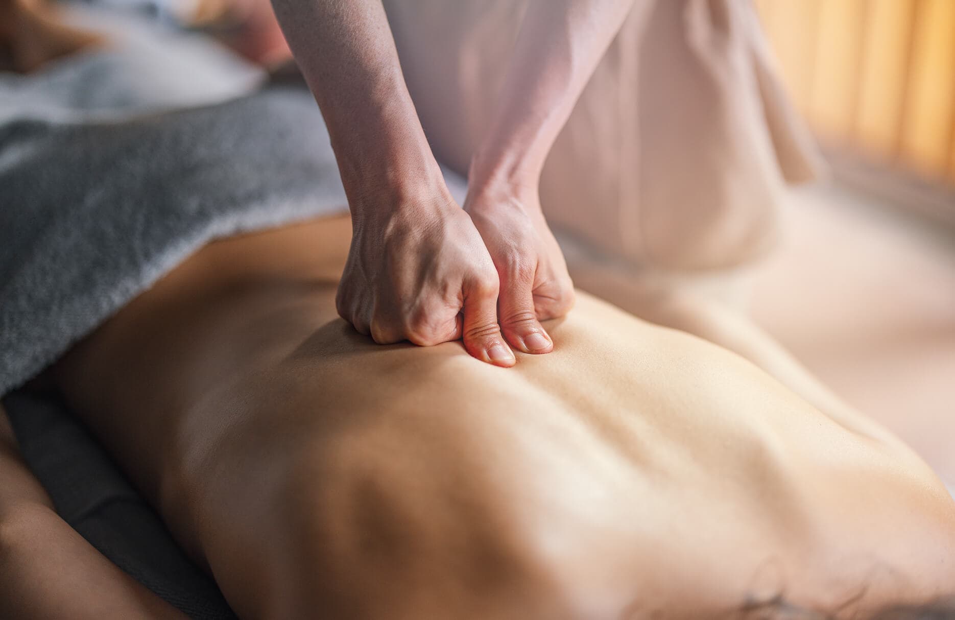 Massage therapist performing deep tissue massage