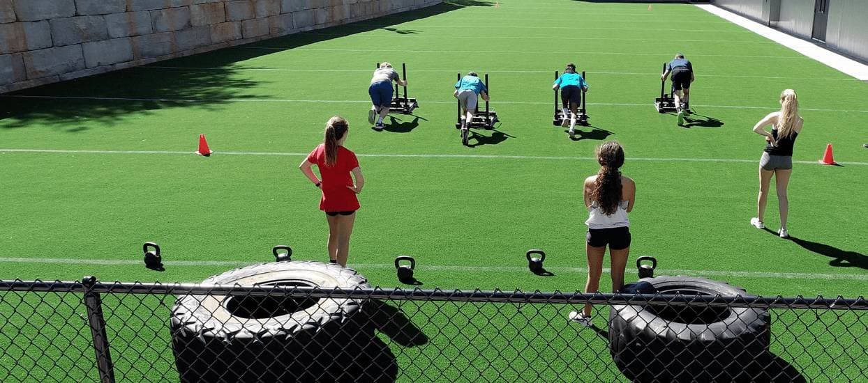 Group fitness class on artificial turf field