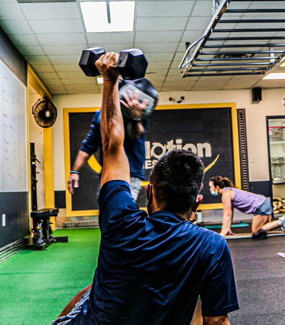 Man doing dumbbell shoulder press exercise
