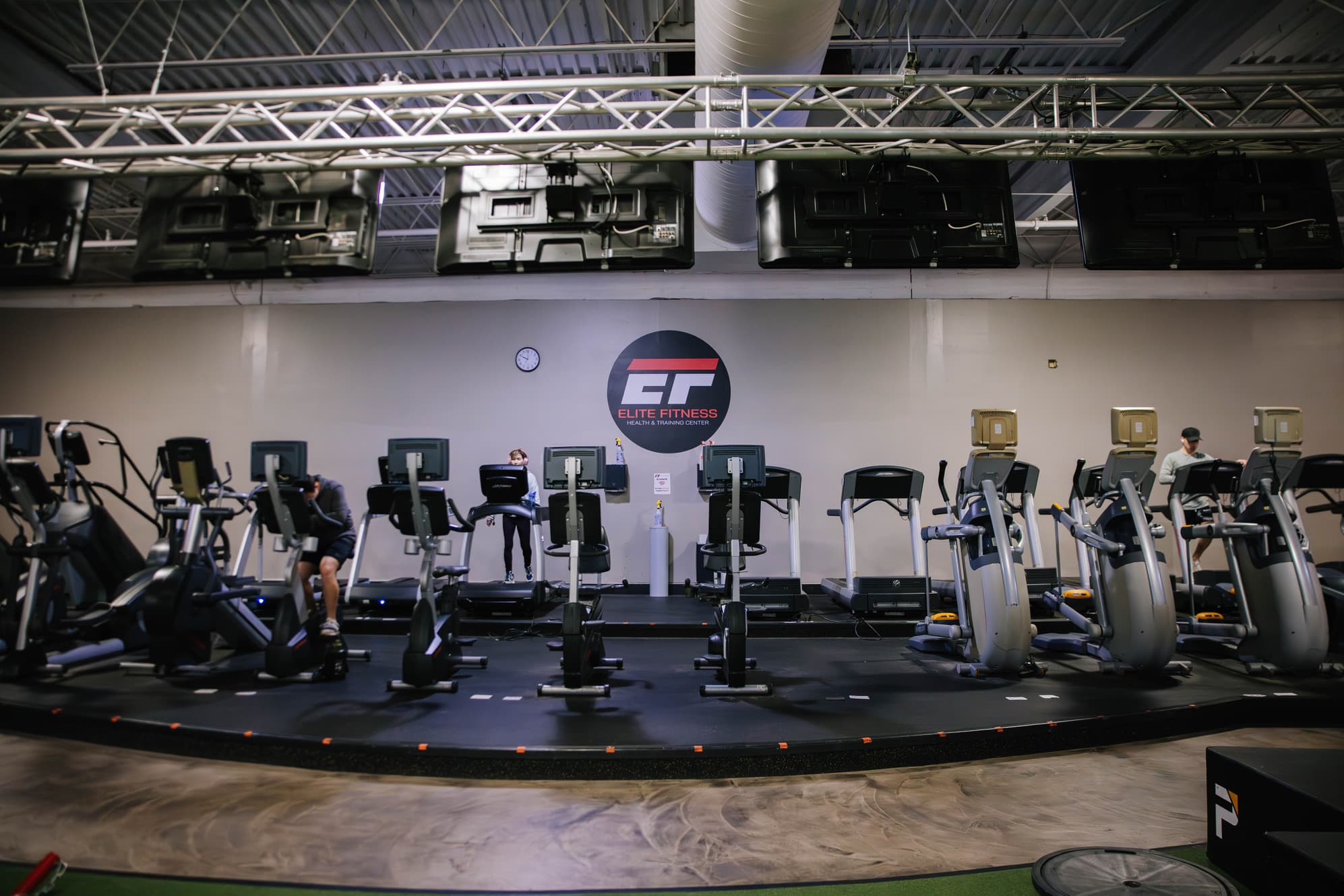 Interior gym with cardio equipment and branding