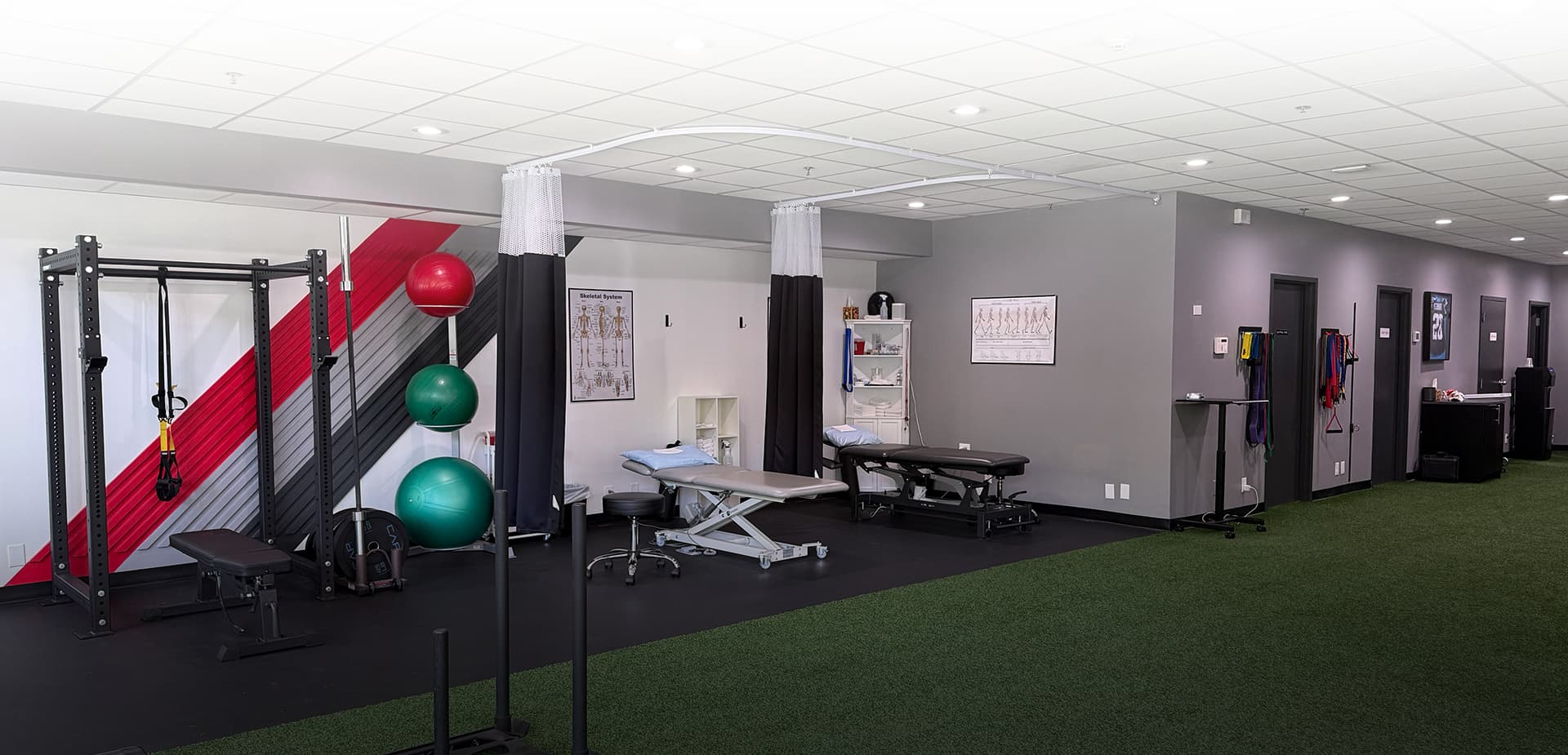 Interior gym with exercise equipment and staff