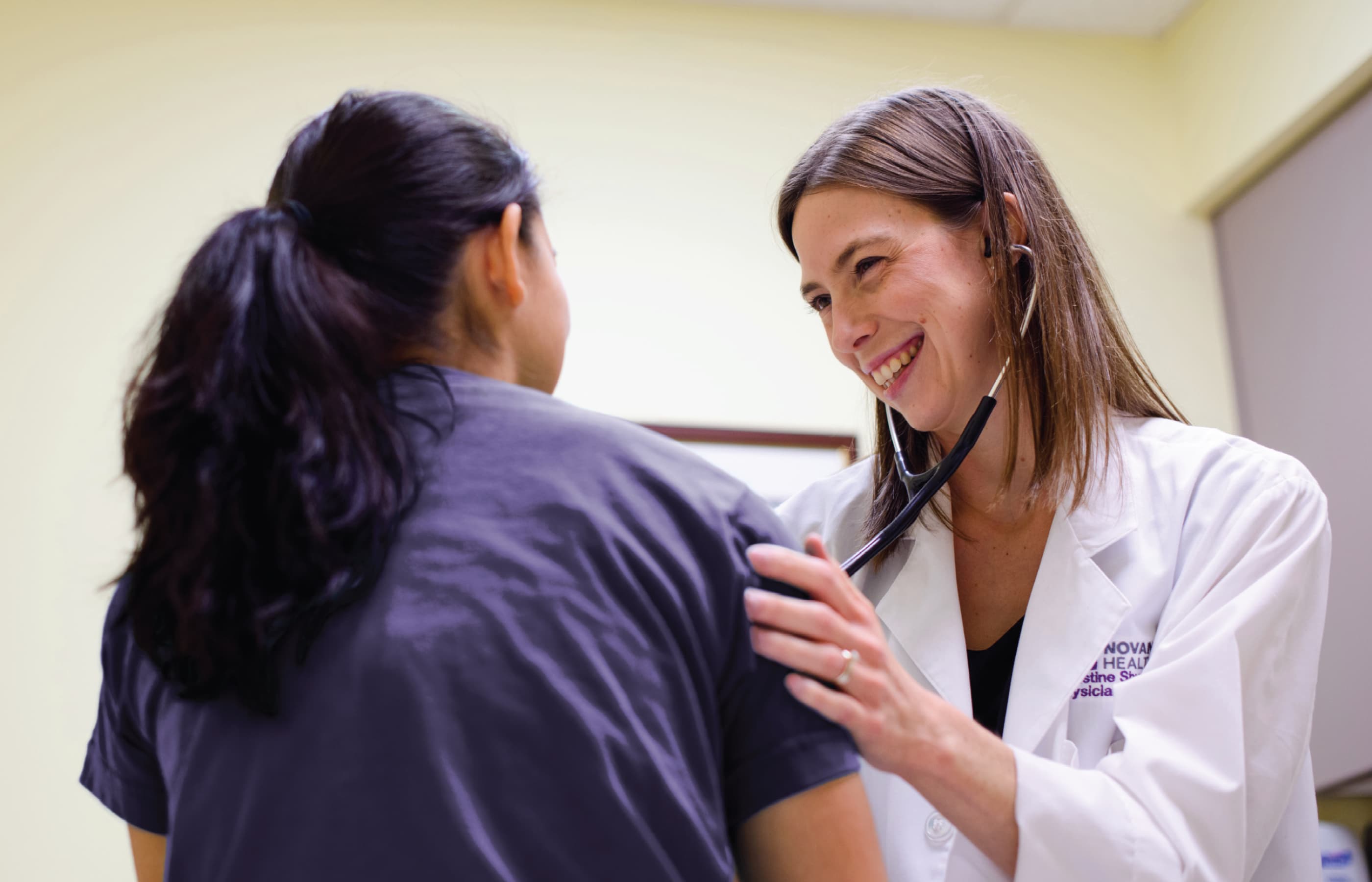 Doctor examining patient with stethoscope