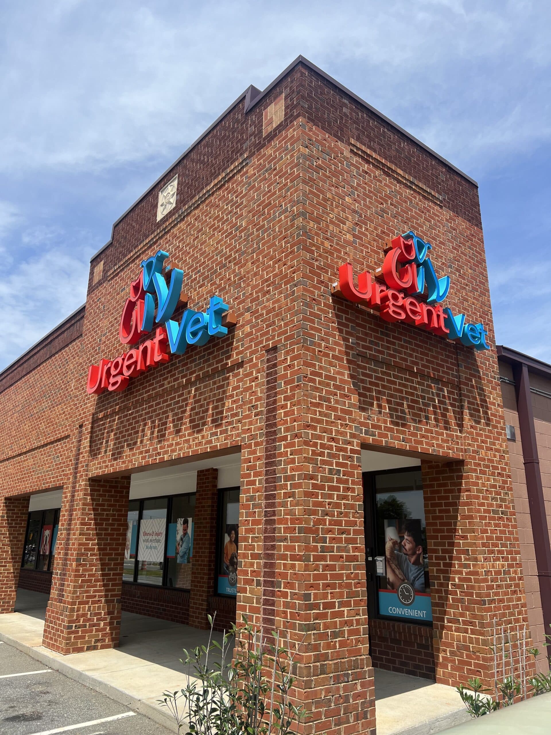 Brick storefront with UrgentVet signage and clock