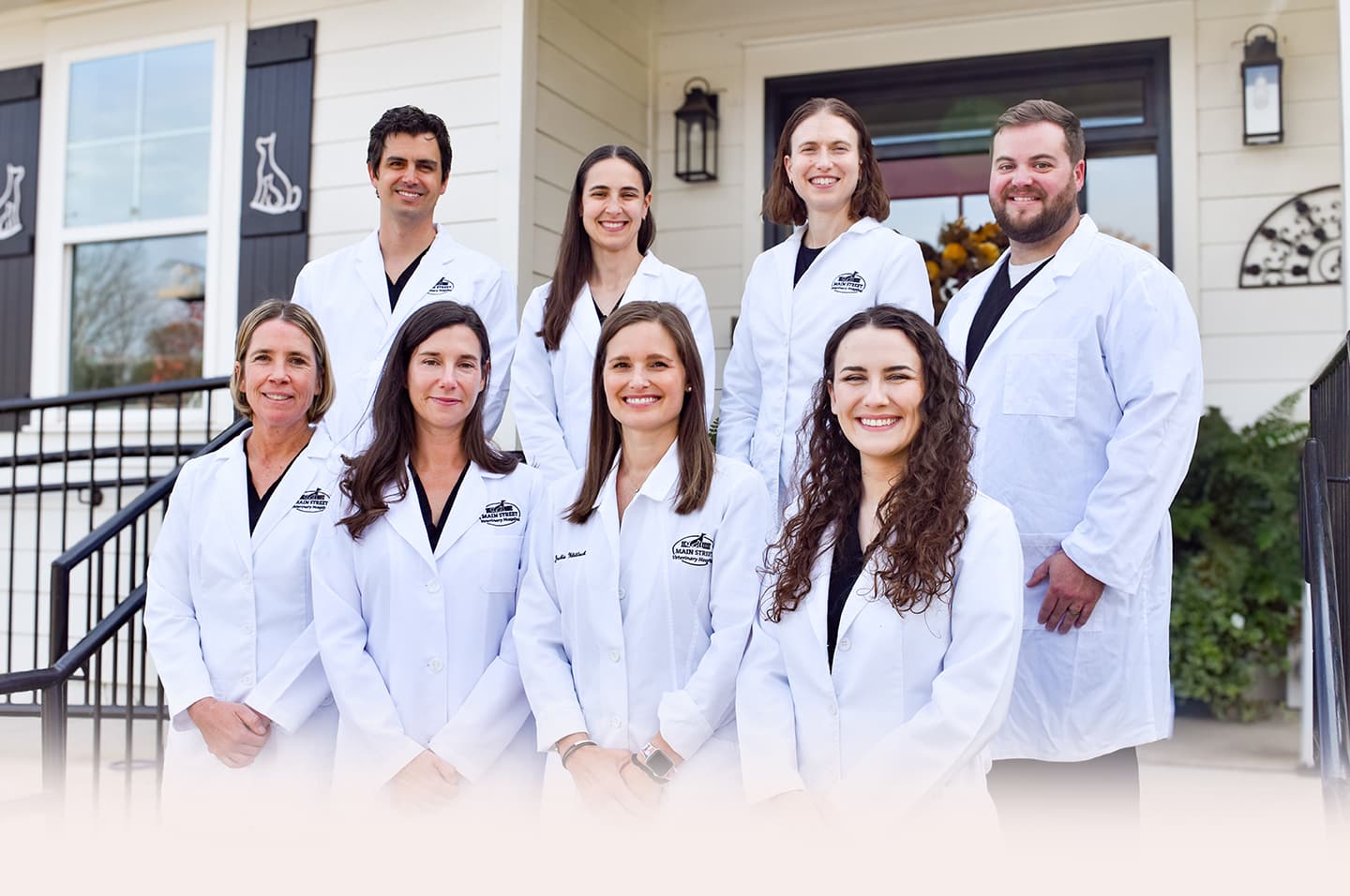 Team of veterinarians outside clinic building