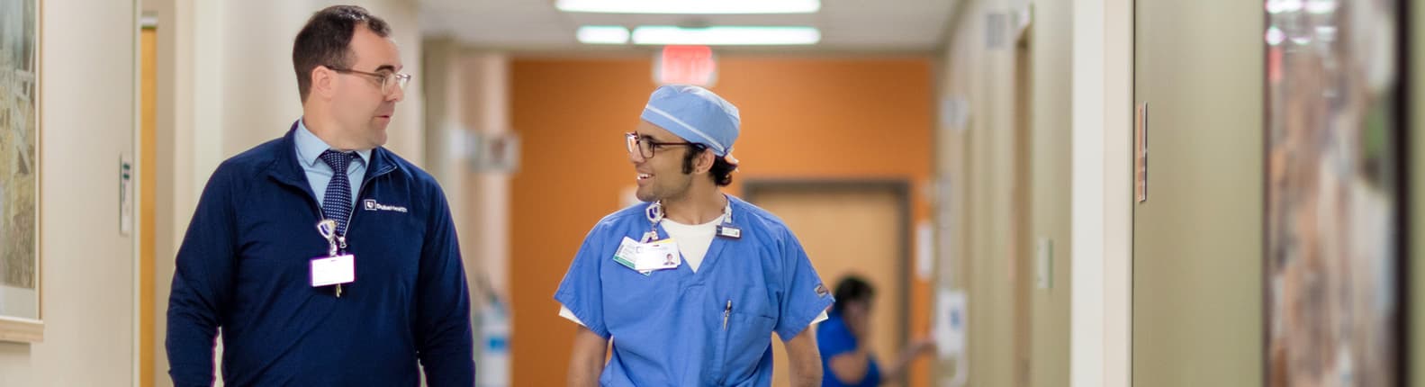 Hospital staff walking in corridor during work