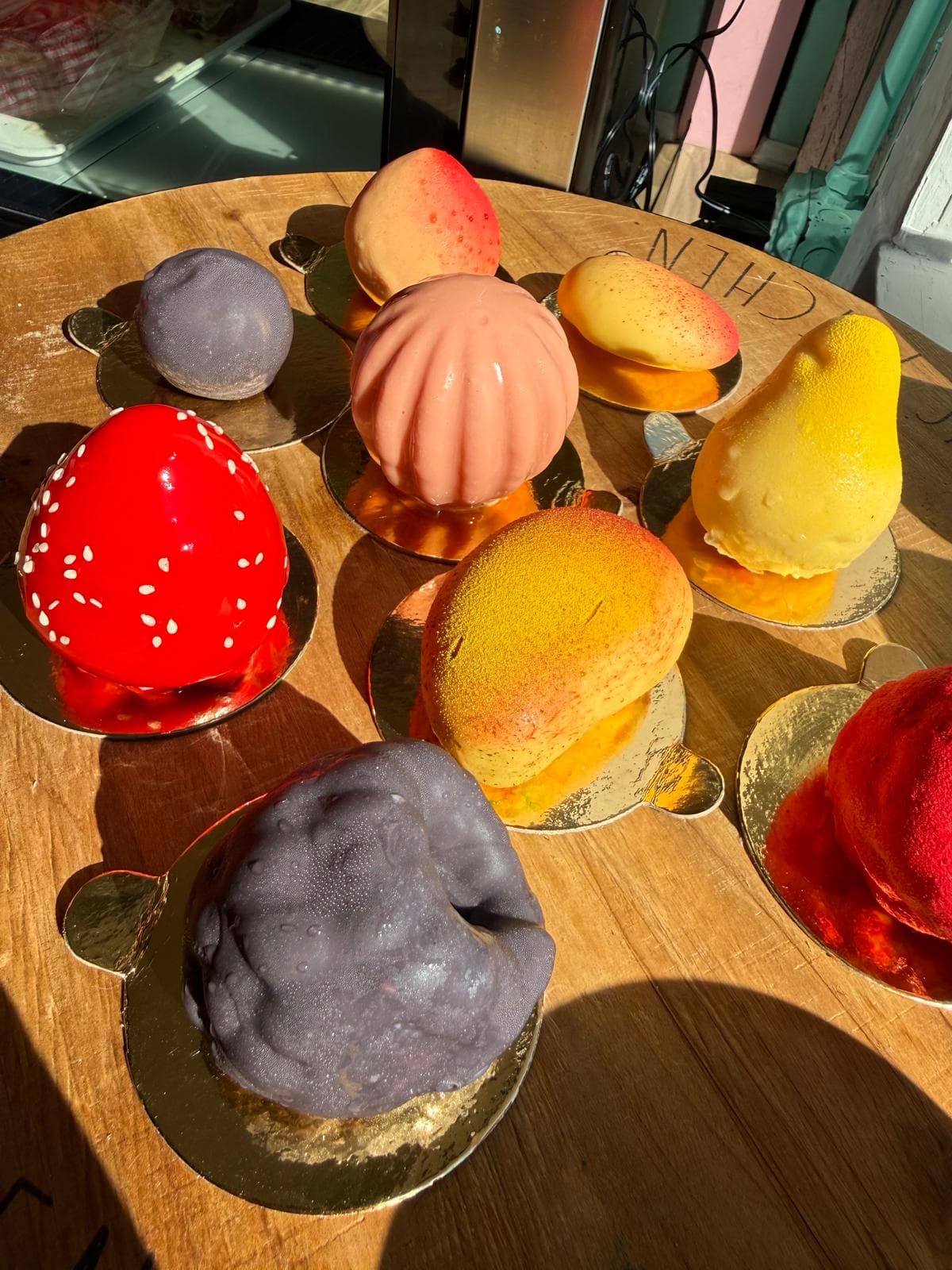 Colorful dome-shaped pastries and desserts display