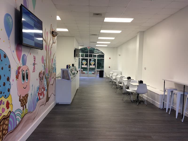 Interior of creamery with seating and colorful wall mural