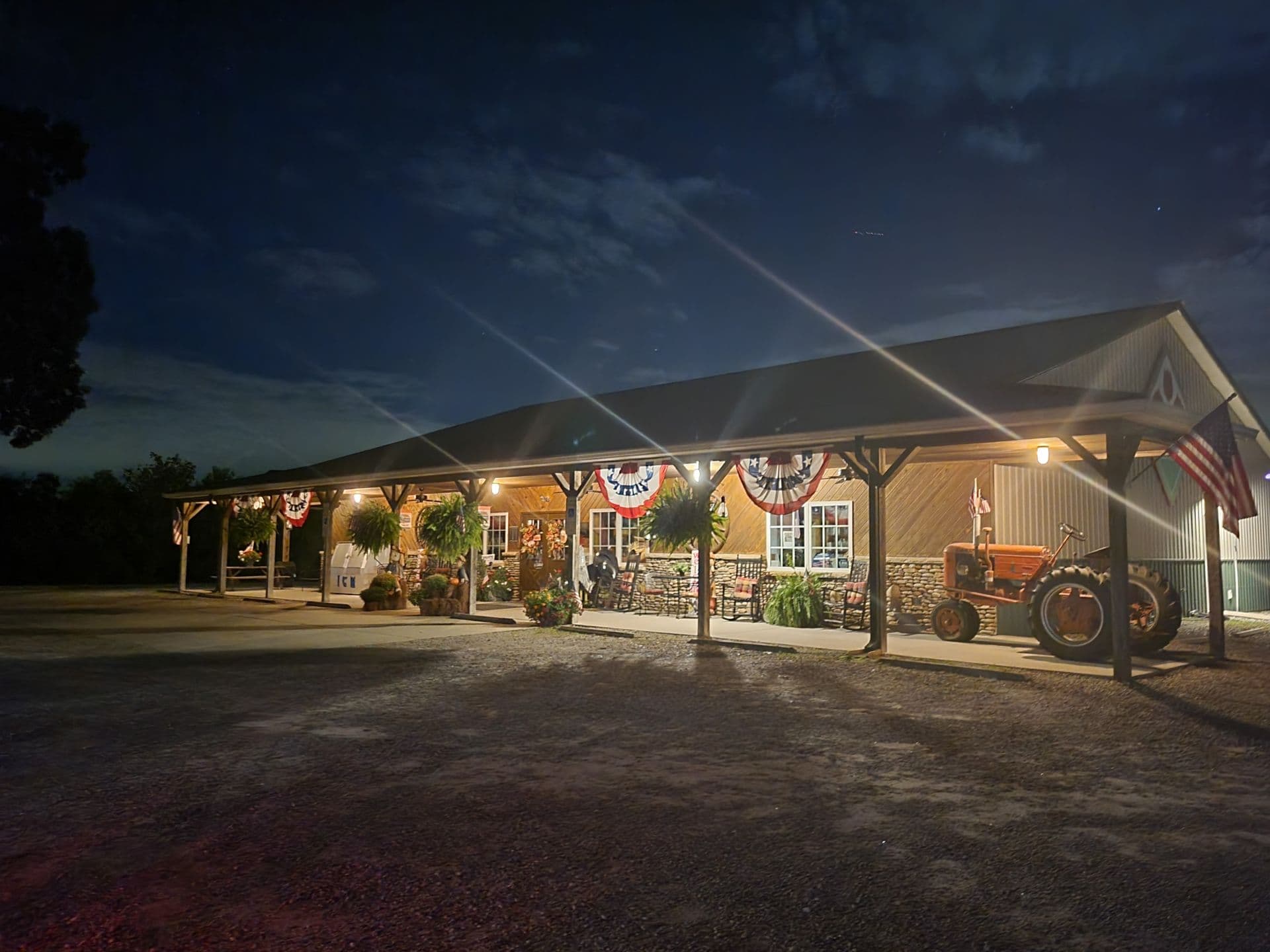 Storefront at night with lit exterior and covered porch