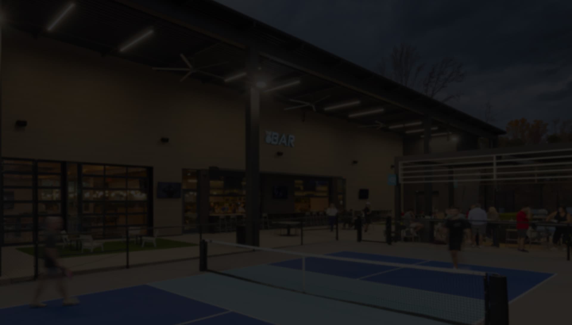 Indoor pickleball courts with bar signage