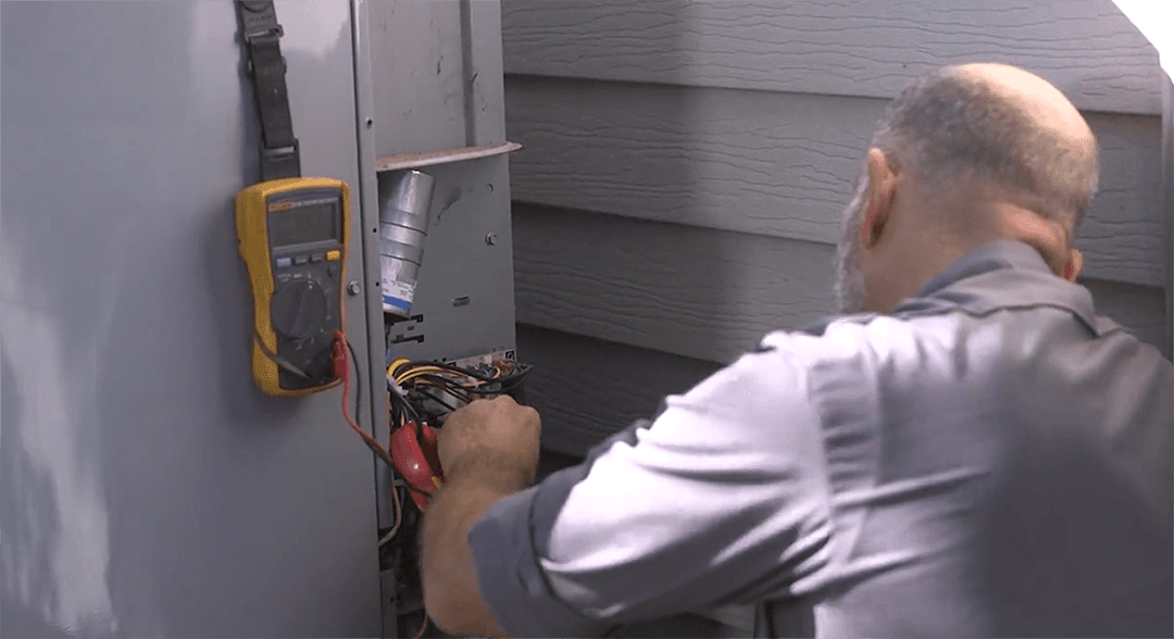 Technician performing HVAC electrical work