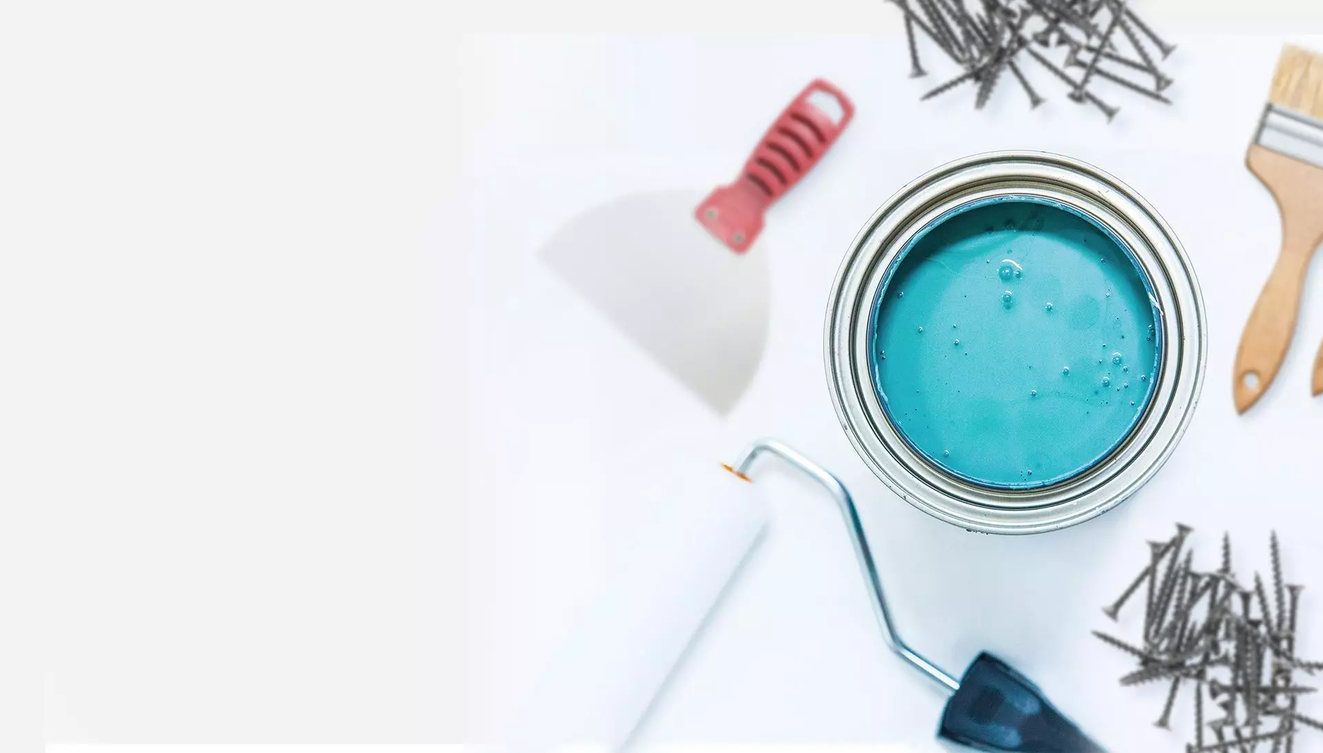 Turquoise paint can with brushes and tools