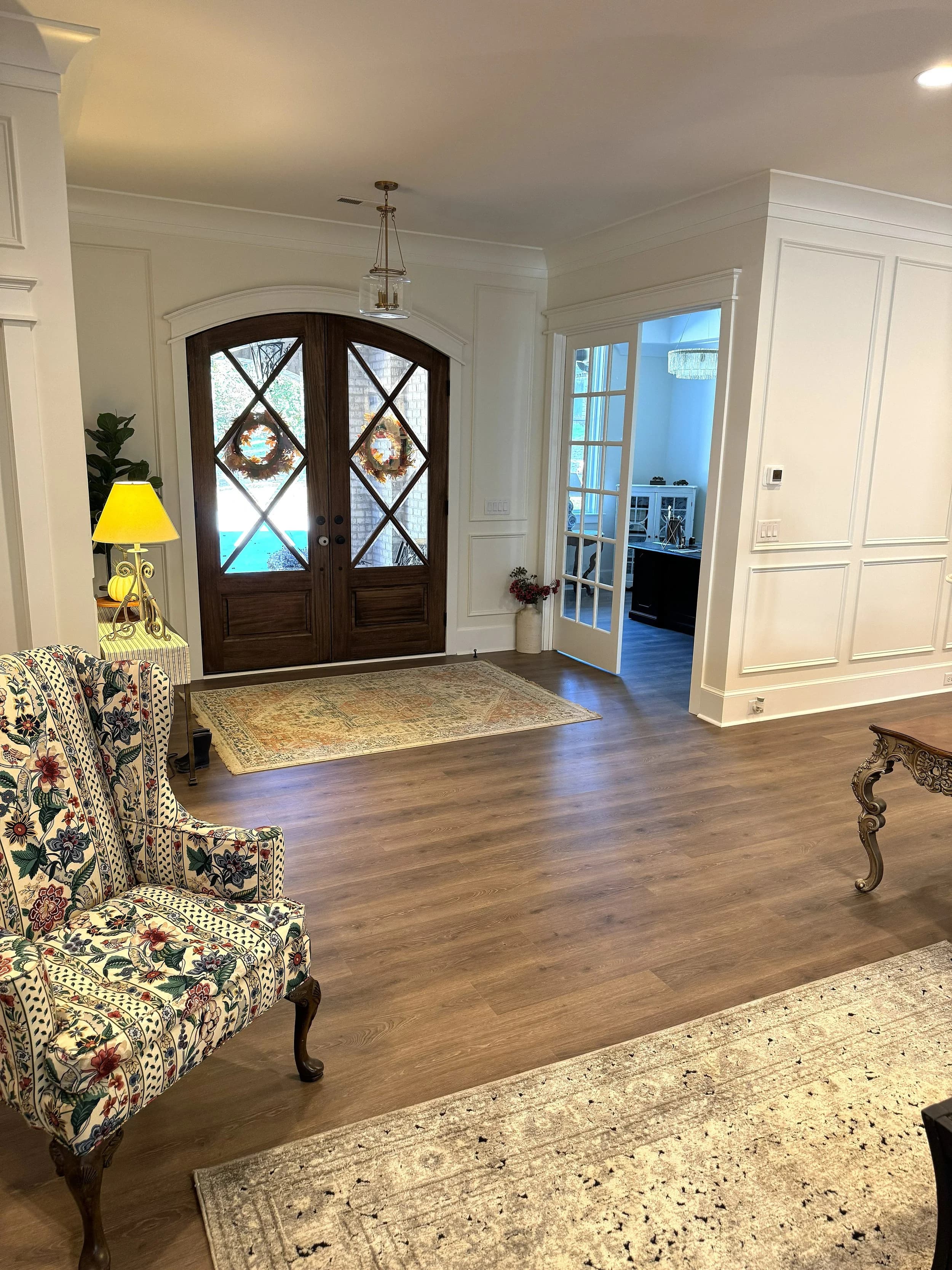 Elegant foyer with dark wood doors and hardwood flooring