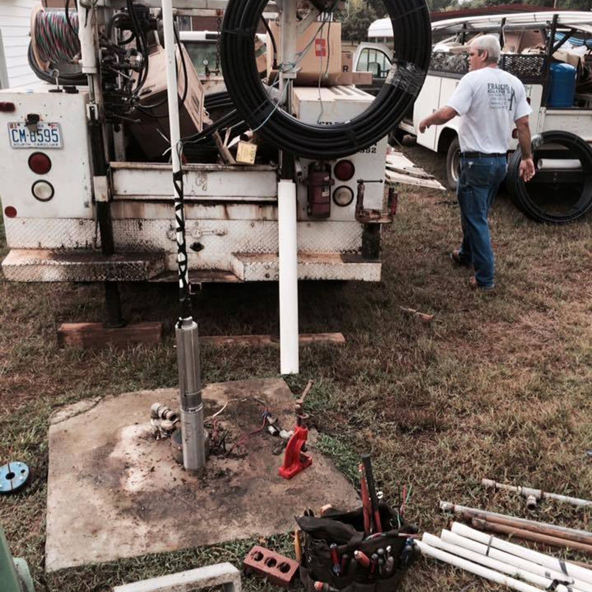 Well pump installation with service truck