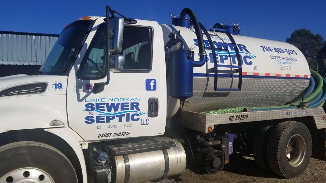 Sewer service truck with company branding