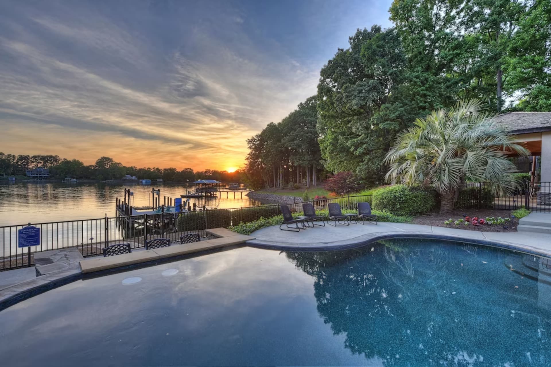Waterfront pool and sunset over lake