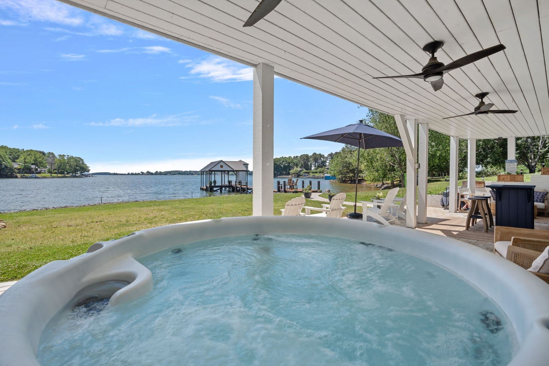 Hot tub on patio overlooking waterfront property