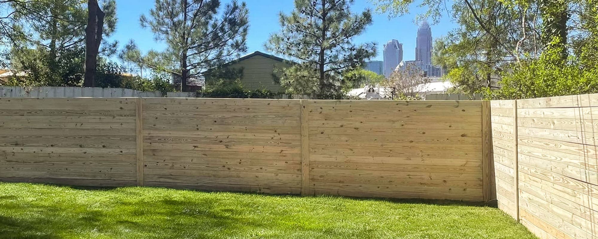 Natural wood privacy fence installation
