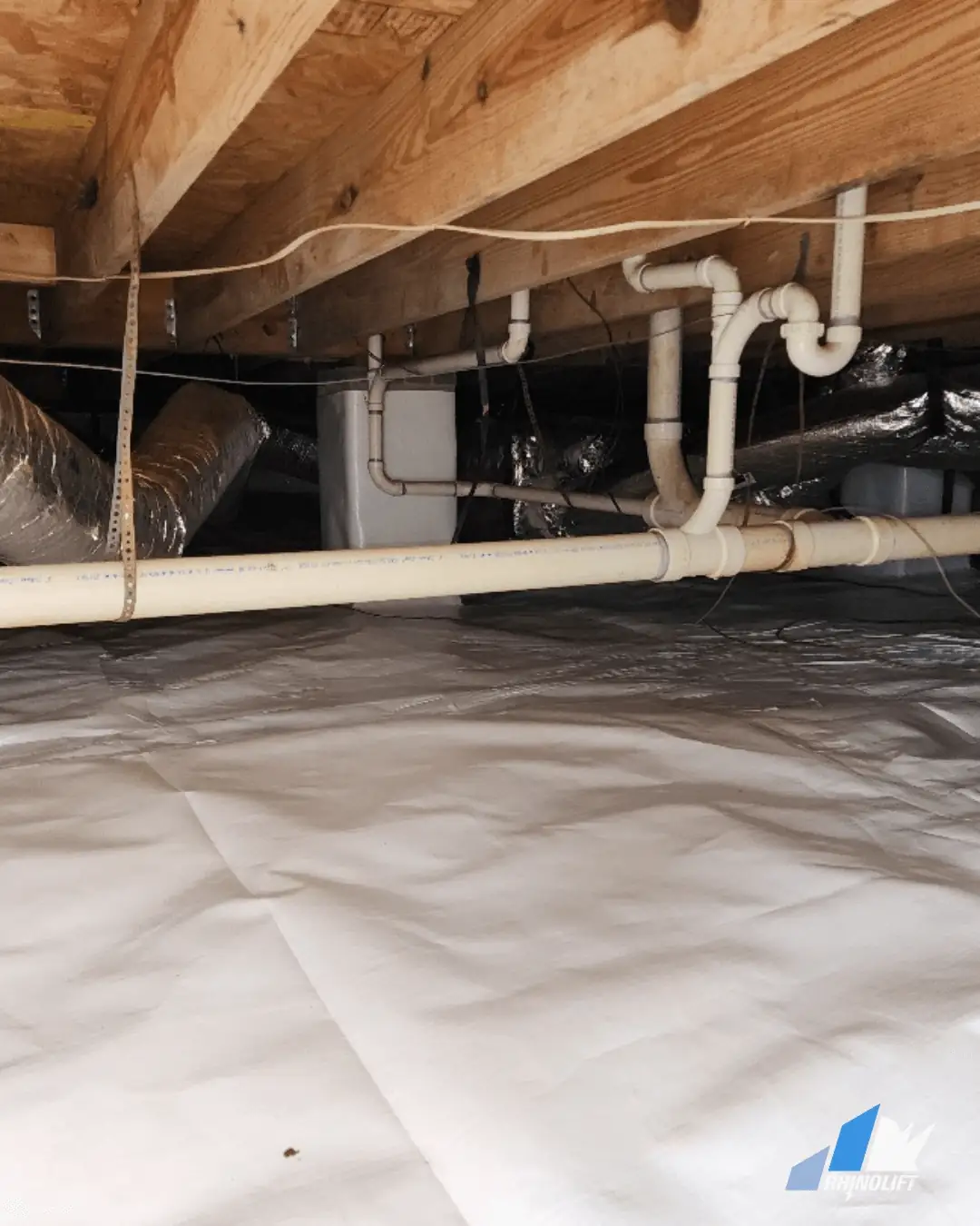 Crawlspace with vapor barrier and piping