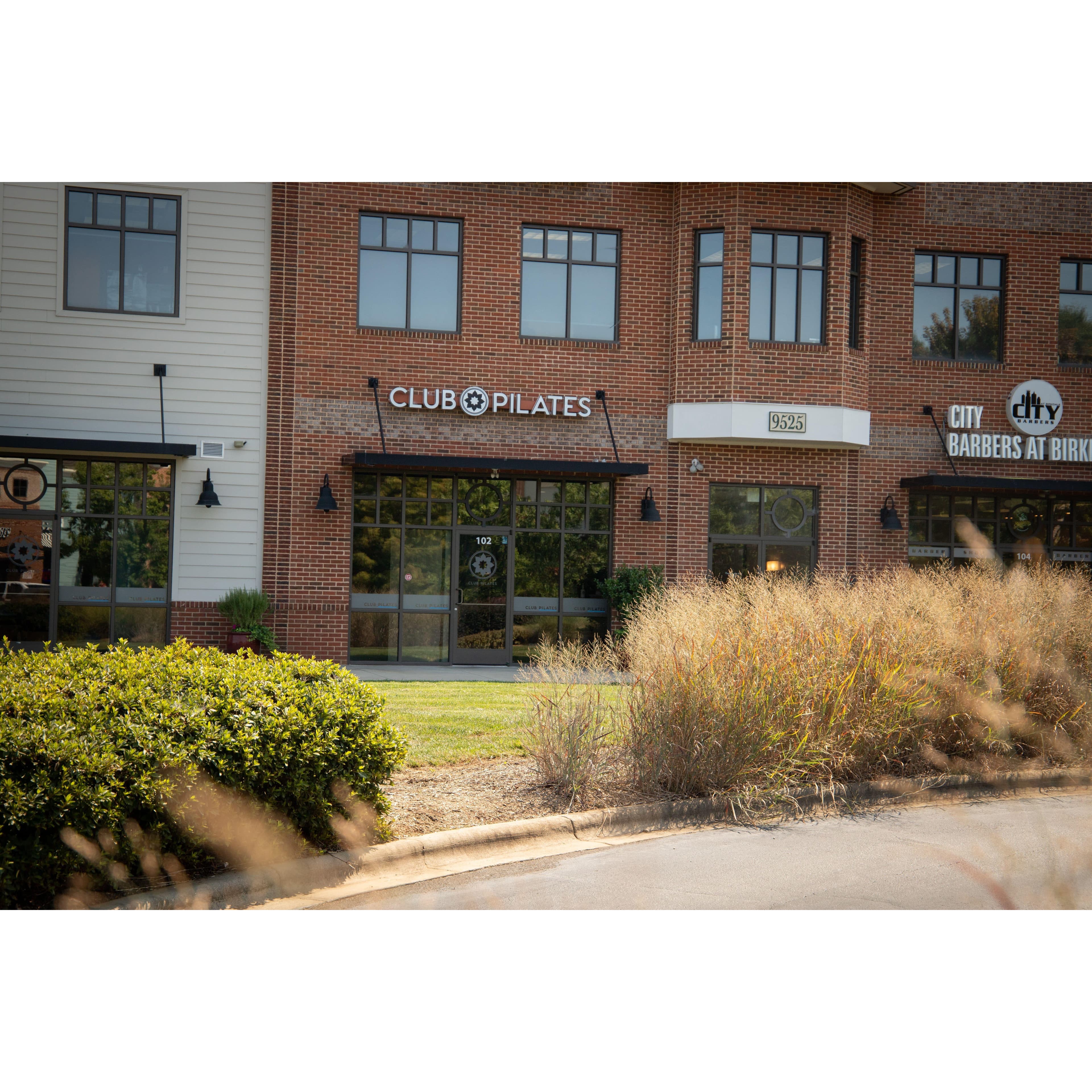 Club Pilates storefront and brick building exterior