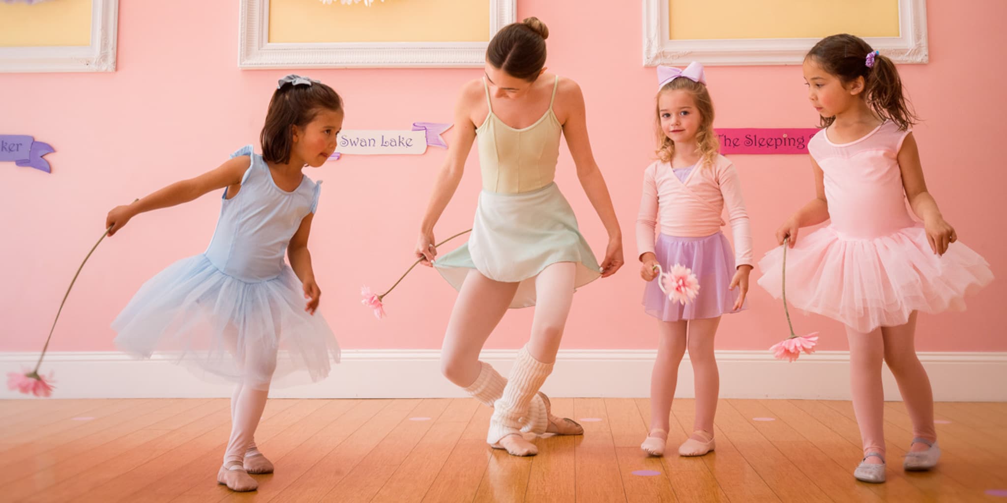 Ballet instructor teaching young students in studio