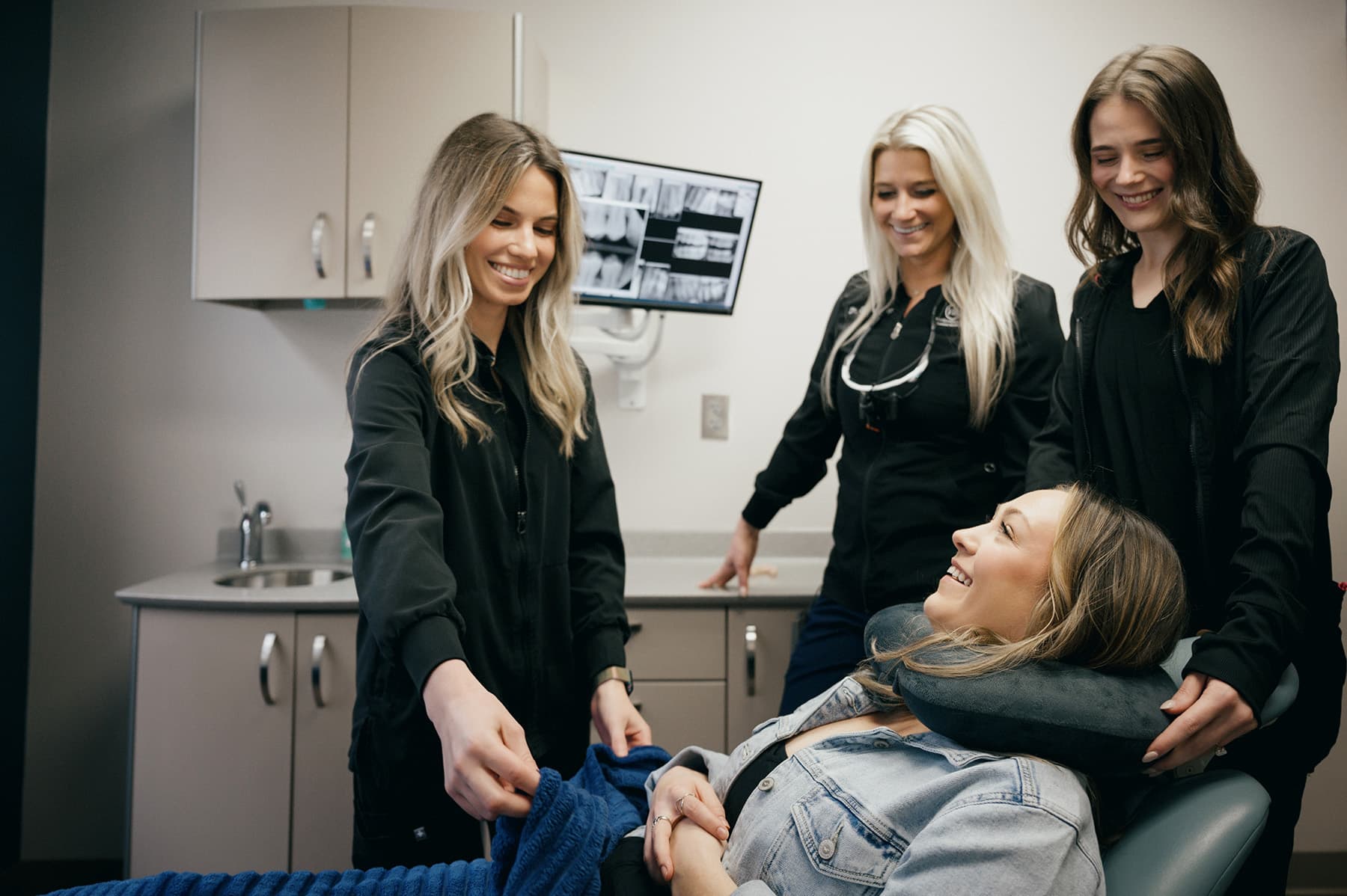 Dental staff with patient in treatment room