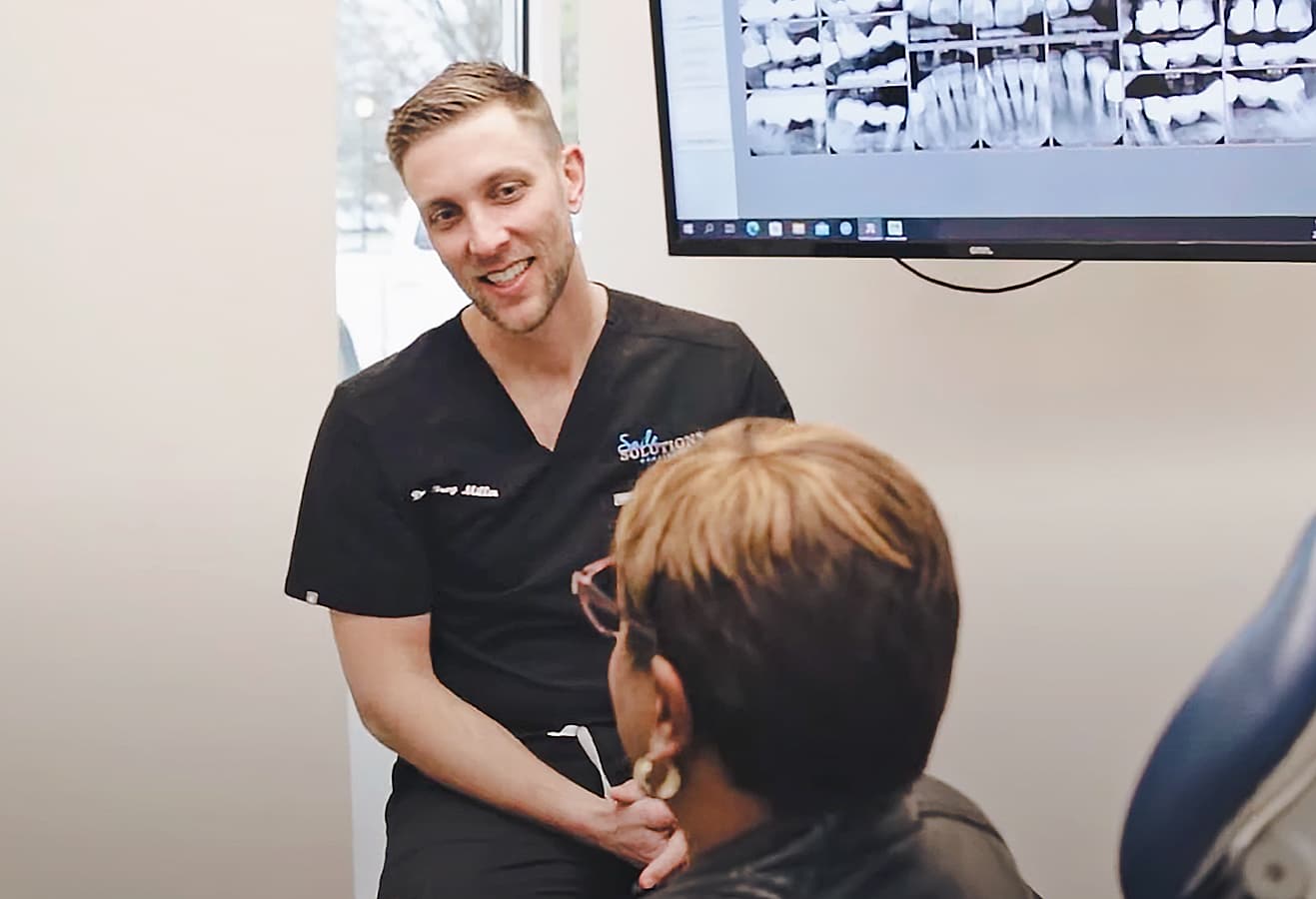 Dentist consulting with patient in office