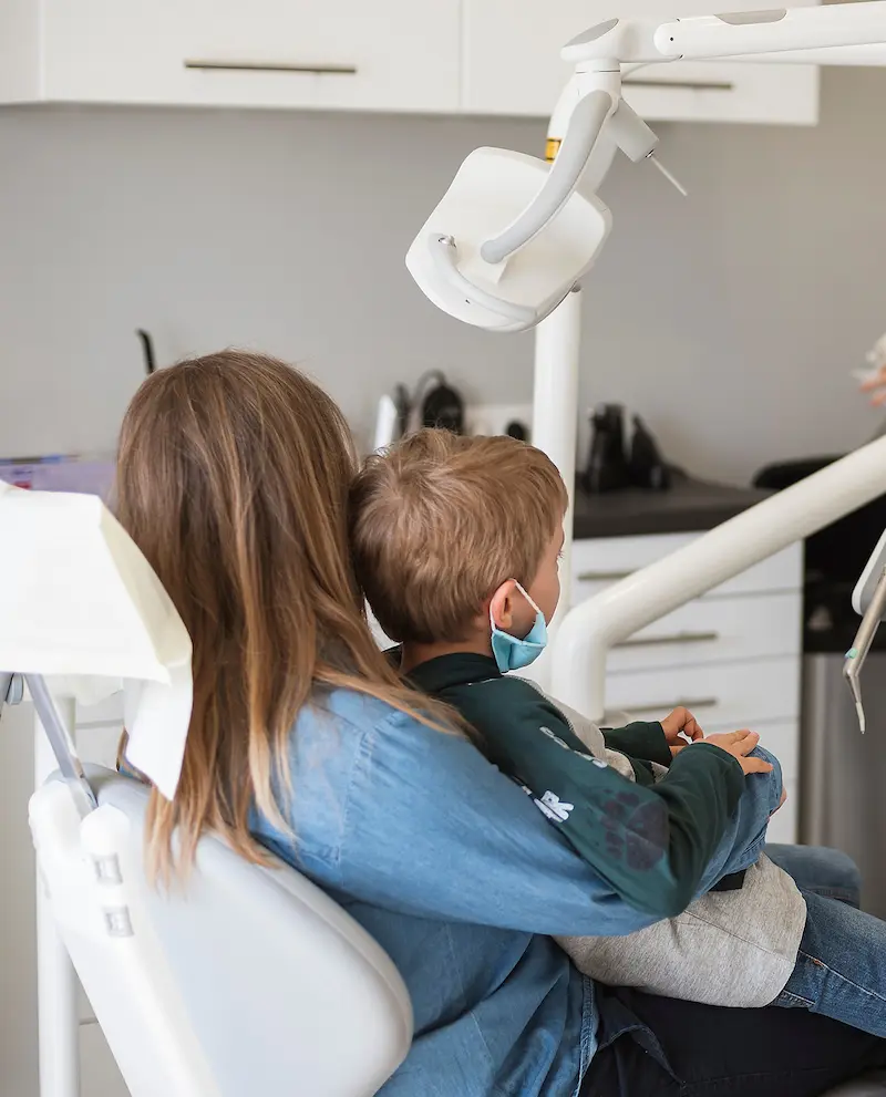 Child receiving dental treatment in operatory