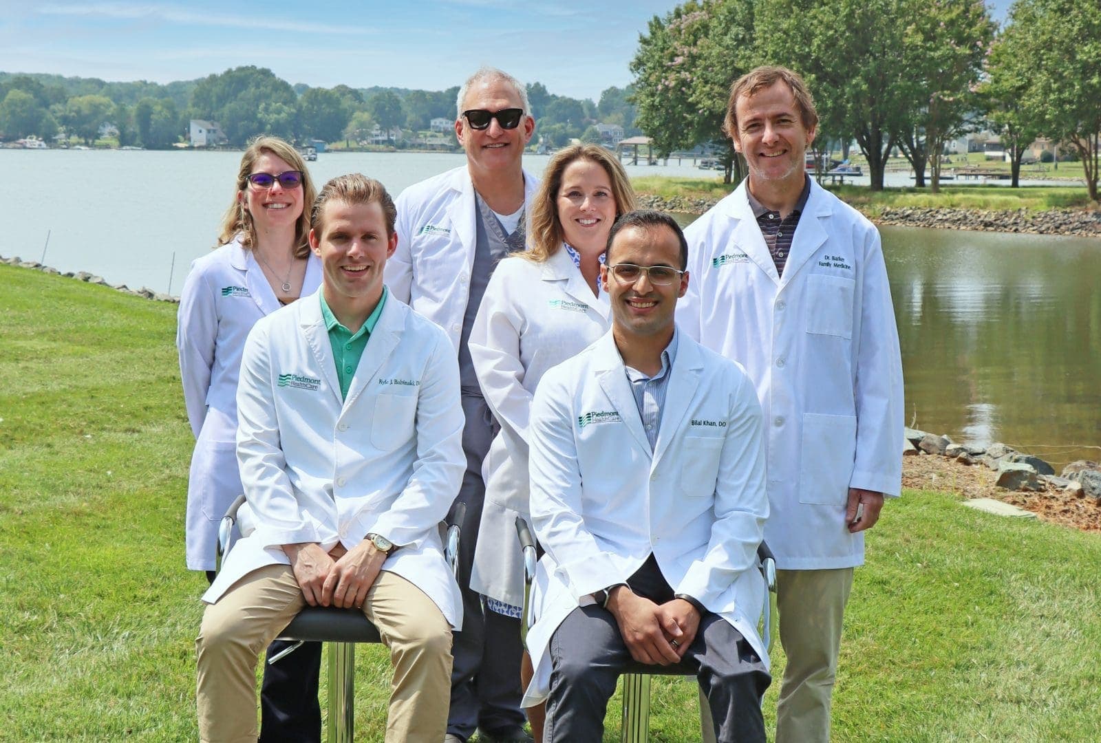 Medical team posing outdoors by waterfront
