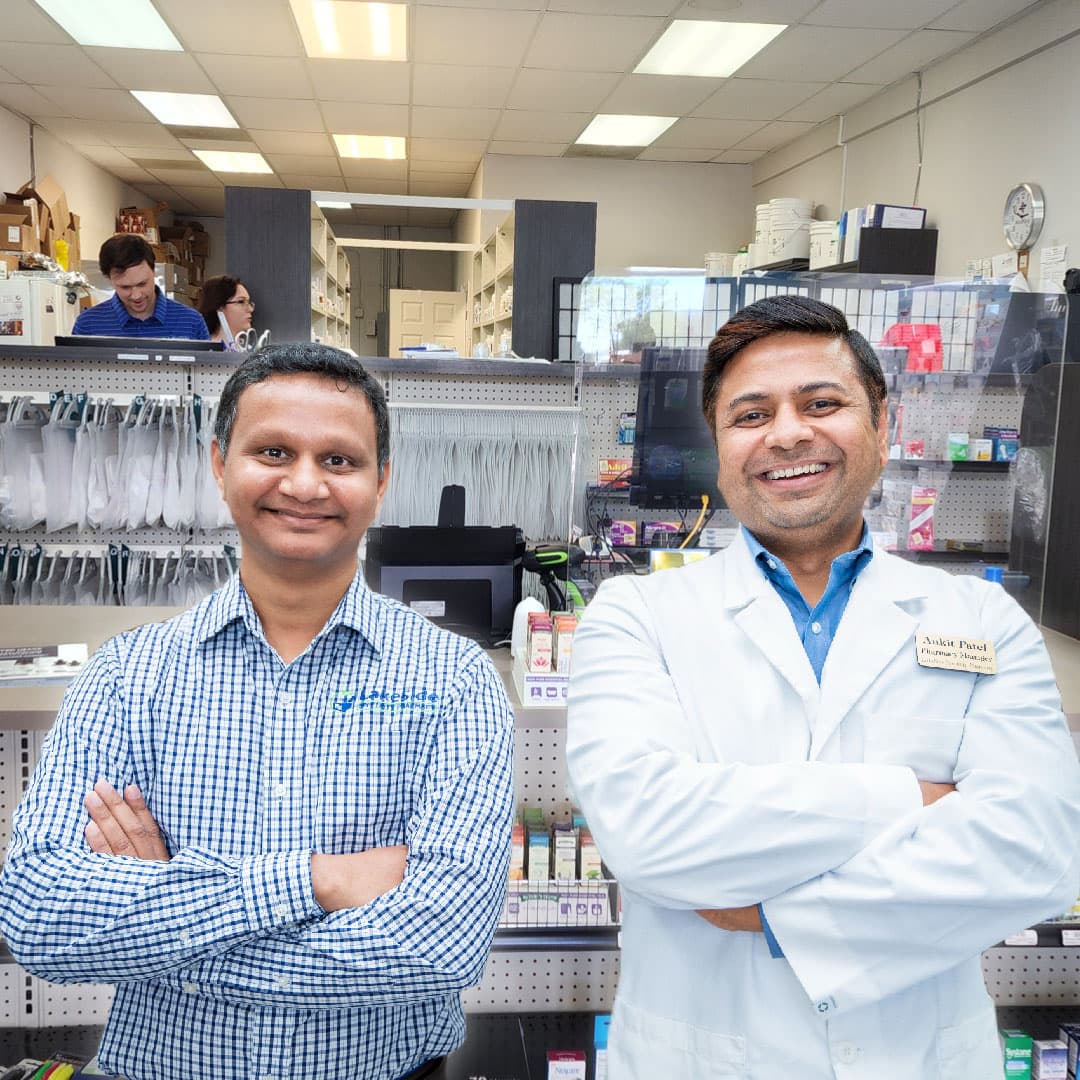 Pharmacy interior with staff and shelved products