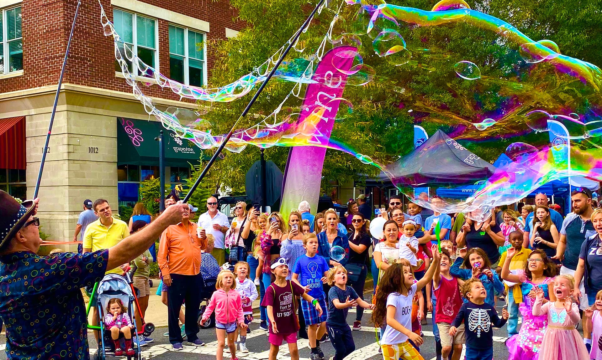 Bubble performers entertaining crowd at street event