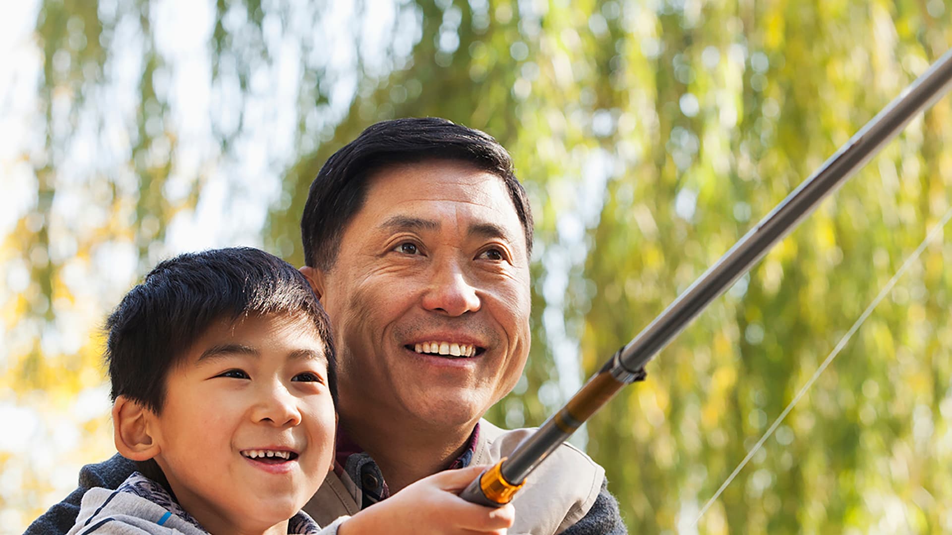 Father and son fishing together outdoors