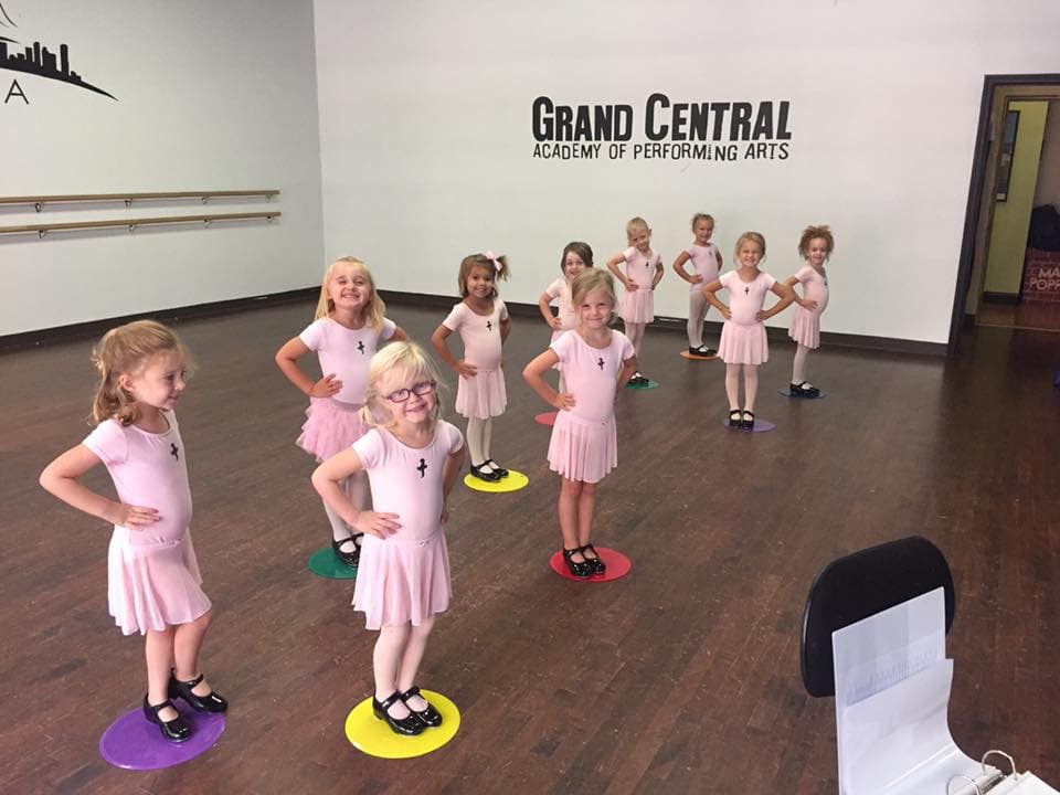 Young dancers in pink dresses at studio