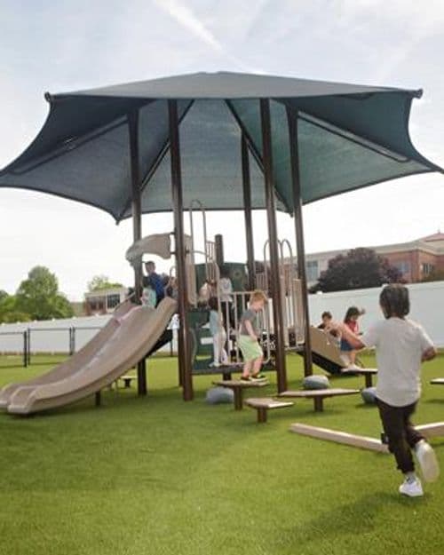 Outdoor playground with shade structure and slide